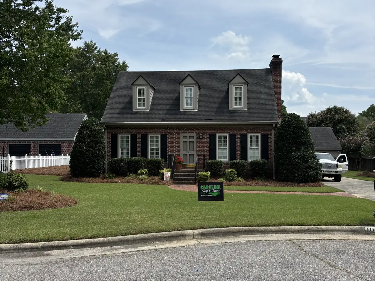 A beautifully striped front lawn maintained by Carolina Turf & Lawn