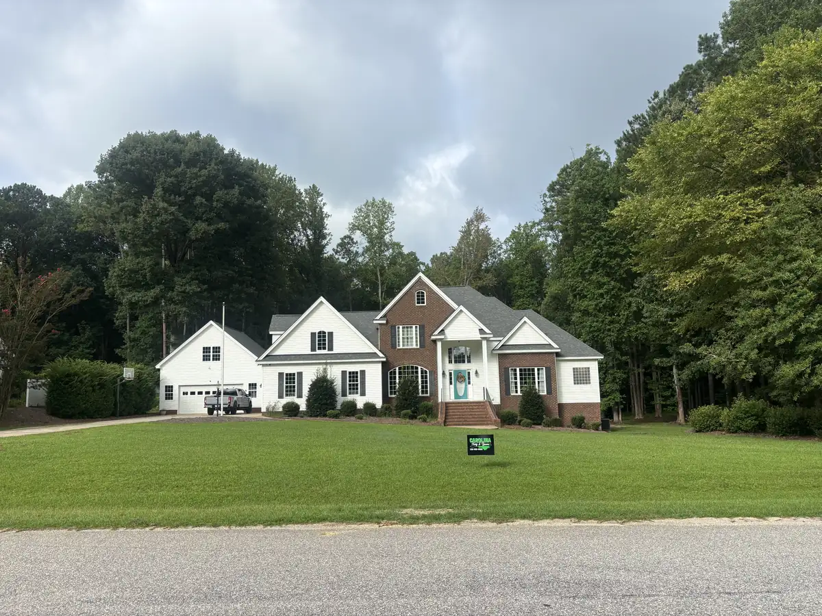 Wide open lawn cut and edged on a two-story property